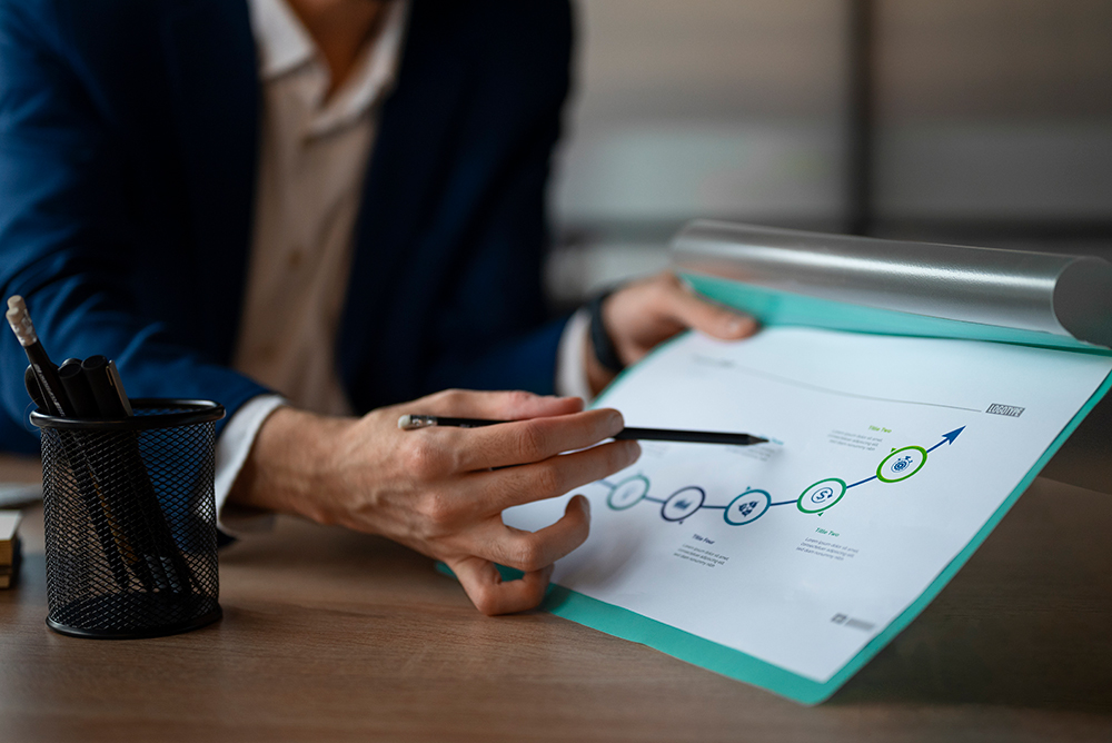Person reviewing progress report and project timeline symbolizing public deliverables submitted to the European Commission within the BIO4COAT project.