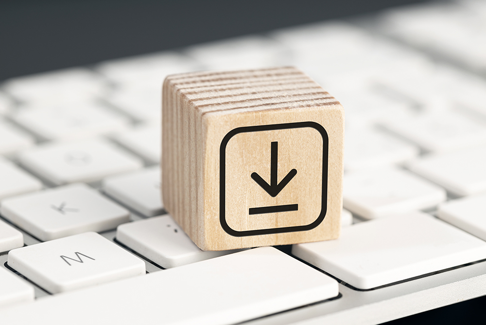 Wooden cube with download icon on computer keyboard symbolizing access to BIO4COAT communication materials and resources on sustainable biobased coatings.
