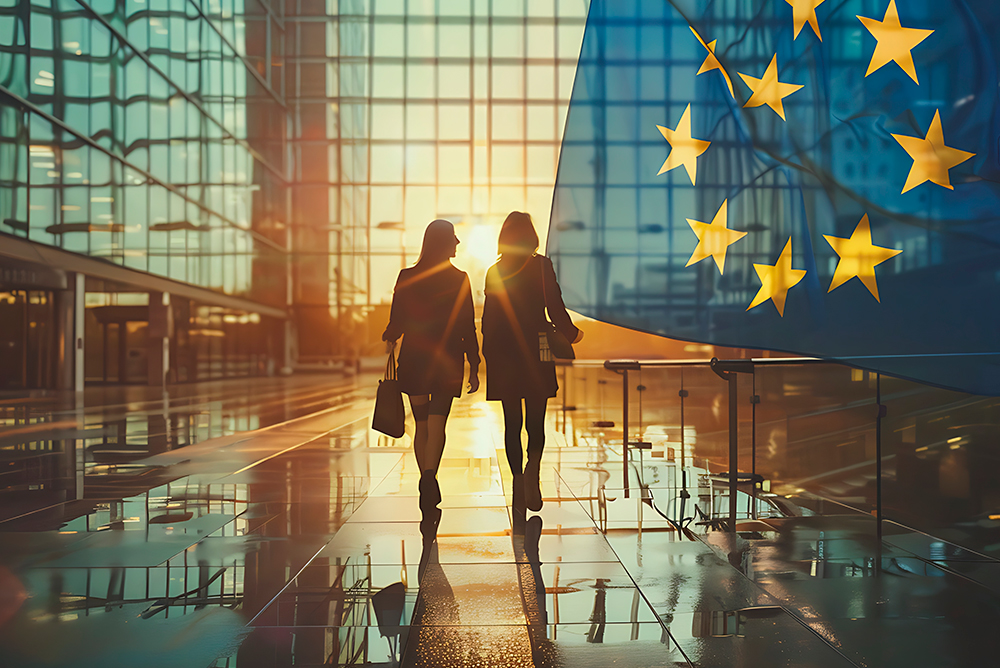 Two professionals walking beside the European Union flag symbolizing international collaboration within the BIO4COAT consortium uniting partners from six countries.